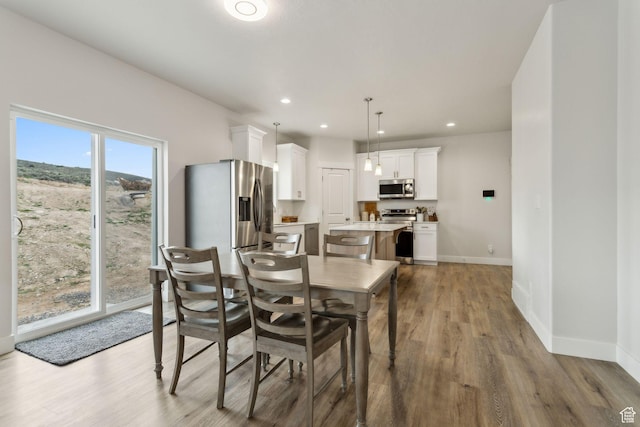 7936 N Bristlecone Rd, Eagle Mountain, UT 84005 - dining area featuring wood finished floors, baseboards, and recessed lighting