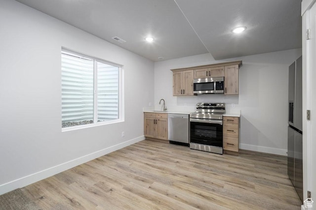7936 N Bristlecone Rd, Eagle Mountain, UT 84005 - kitchen featuring stainless steel appliances, light brown cabinetry, baseboards, light wood-type flooring, and recessed lighting
