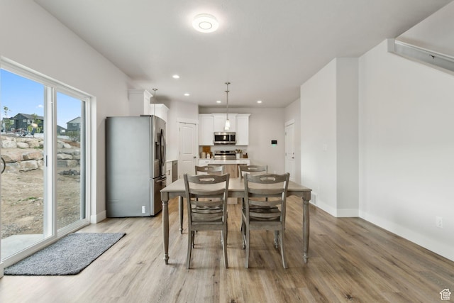 7936 N Bristlecone Rd, Eagle Mountain, UT 84005 - dining area with light wood finished floors, baseboards, and recessed lighting