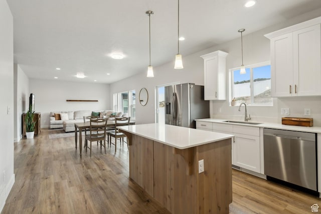 7936 N Bristlecone Rd, Eagle Mountain, UT 84005 - kitchen with appliances with stainless steel finishes, a sink, open floor plan, white cabinetry, and recessed lighting