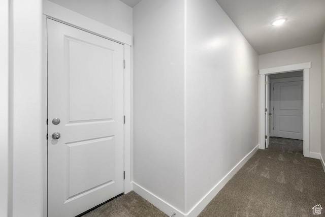 7936 N Bristlecone Rd, Eagle Mountain, UT 84005 - hallway featuring dark colored carpet and baseboards