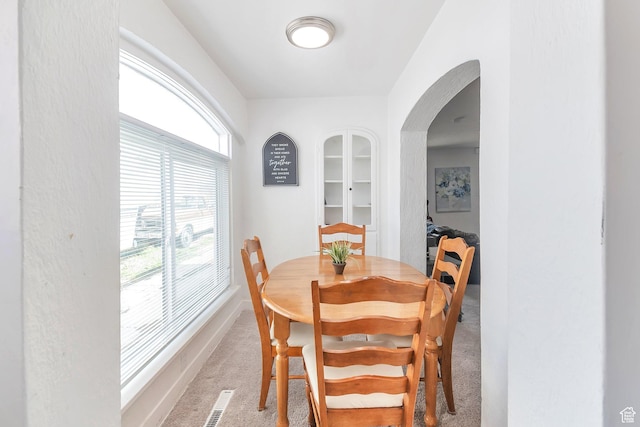 185 N 200 W, Delta, UT 84624 - dining room featuring carpet floors, arched walkways, and baseboards