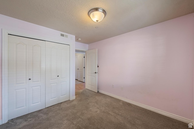 191 E Spencer Peak Way Unit I2, Draper, UT 84020 - unfurnished bedroom featuring carpet, a closet, baseboards, and a textured ceiling
