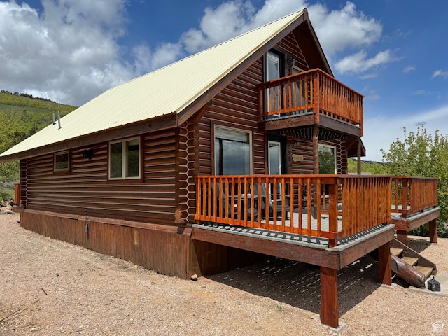 395 Hickock Dr Unit 309, Fish Haven, ID 83287 - rear view of house with a balcony, log exterior, metal roof, and a deck