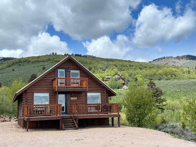 395 Hickock Dr Unit 309, Fish Haven, ID 83287 - back of property featuring a wooden deck, a forest view, and log exterior