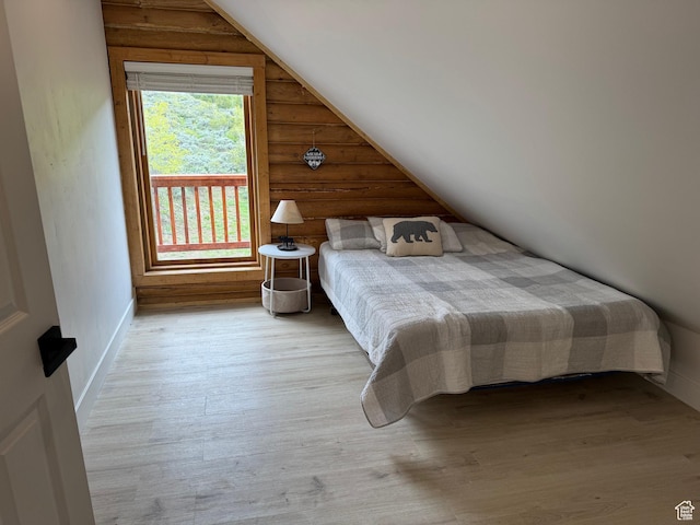 395 Hickock Dr Unit 309, Fish Haven, ID 83287 - bedroom featuring vaulted ceiling, wood finished floors, and rustic walls