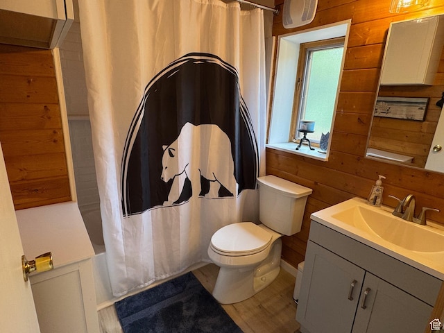 395 Hickock Dr Unit 309, Fish Haven, ID 83287 - bathroom featuring toilet, vanity, wooden walls, shower / bath combination with curtain, and wood finished floors