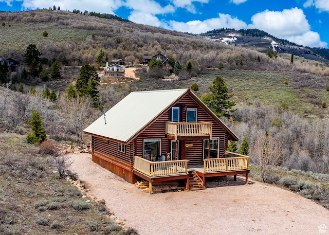 395 Hickock Dr Unit 309, Fish Haven, ID 83287 - view of front of house with a deck with mountain view, log exterior, and metal roof