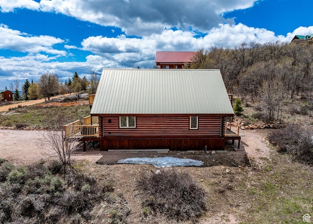 395 Hickock Dr Unit 309, Fish Haven, ID 83287 - view of side of home featuring log siding, a wooden deck, and metal roof