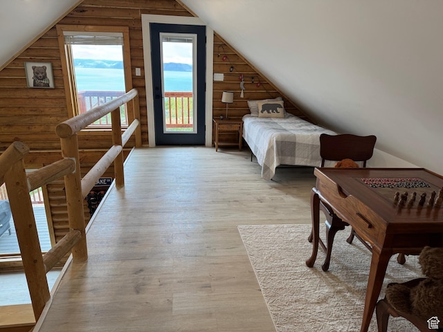 395 Hickock Dr Unit 309, Fish Haven, ID 83287 - bedroom featuring rustic walls, access to outside, vaulted ceiling, and wood finished floors