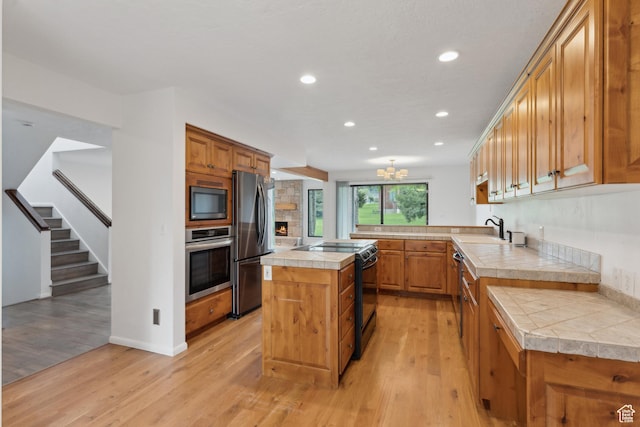 1679 Village Round Dr, Park City, UT 84098 - kitchen featuring black appliances, light wood finished floors, recessed lighting, a sink, and tile counters