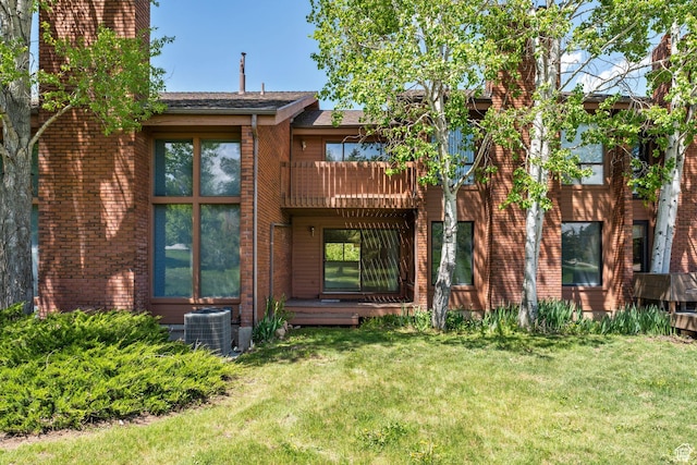 1679 Village Round Dr, Park City, UT 84098 - back of house with cooling unit, a lawn, a chimney, and a balcony