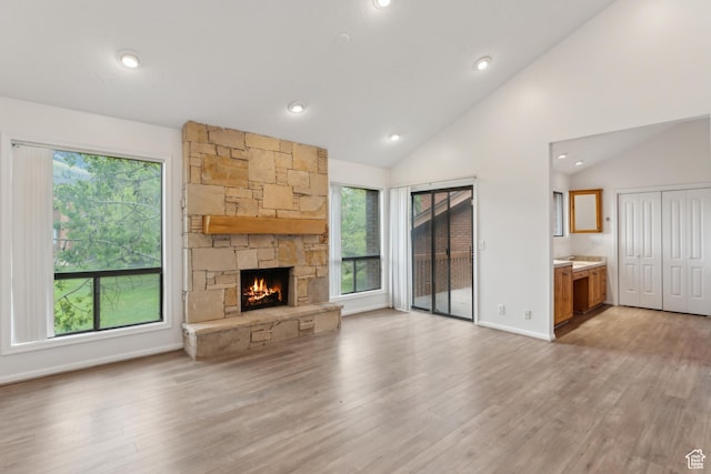 1679 Village Round Dr, Park City, UT 84098 - unfurnished living room featuring vaulted ceiling, a fireplace, light wood-type flooring, recessed lighting, and baseboards