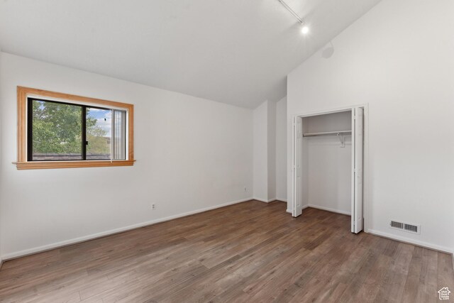 1679 Village Round Dr, Park City, UT 84098 - unfurnished bedroom featuring wood finished floors, vaulted ceiling, and baseboards
