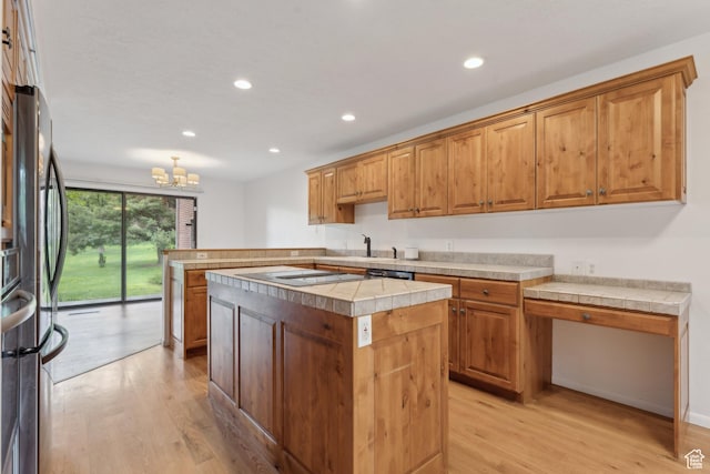 1679 Village Round Dr, Park City, UT 84098 - kitchen with light wood finished floors, recessed lighting, a chandelier, a peninsula, and a kitchen island