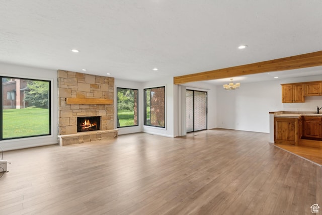 1679 Village Round Dr, Park City, UT 84098 - unfurnished living room featuring plenty of natural light, a chandelier, recessed lighting, light wood-type flooring, and beamed ceiling