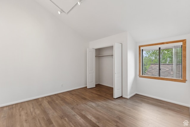 1679 Village Round Dr, Park City, UT 84098 - unfurnished bedroom with vaulted ceiling, wood finished floors, baseboards, and a closet