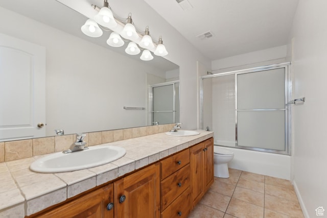 1679 Village Round Dr, Park City, UT 84098 - bathroom featuring toilet, double vanity, tile patterned floors, and bath / shower combo with glass door