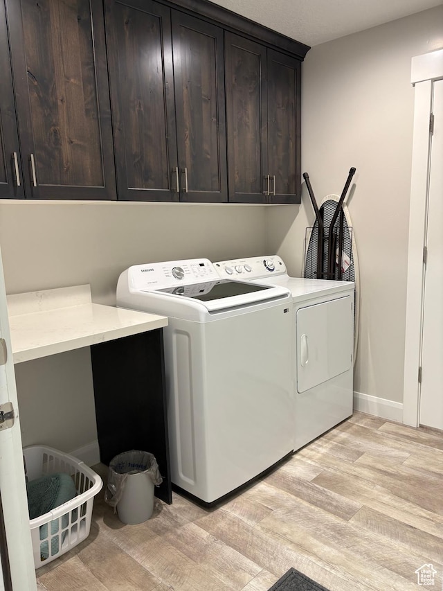 765 E Union St, Manti, UT 84642 - laundry area with cabinet space, washer and clothes dryer, and light wood-type flooring