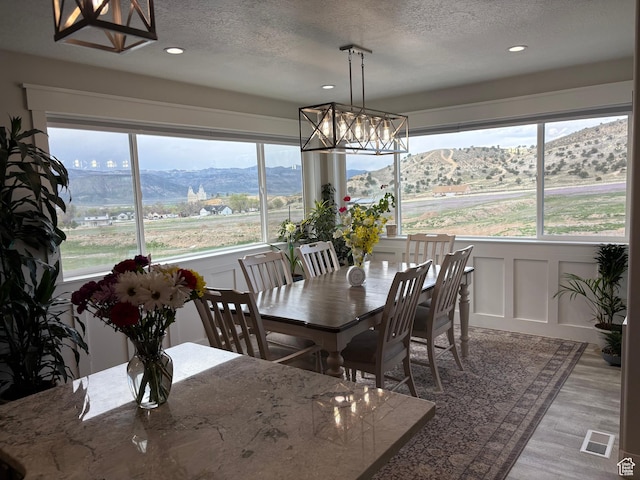 765 E Union St, Manti, UT 84642 - dining area featuring a chandelier, a decorative wall, a textured ceiling, recessed lighting, and wood finished floors