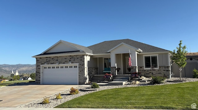 765 E Union St, Manti, UT 84642 - view of front facade featuring concrete driveway, stone siding, an attached garage, a front lawn, and covered porch