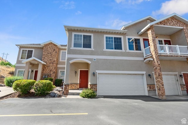 1183 S Canyon Meadow Dr Unit 2, Provo, UT 84606 - view of property with stone siding, stucco siding, an attached garage, a balcony, and asphalt driveway