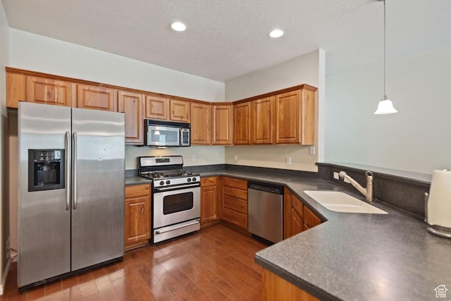 1183 S Canyon Meadow Dr Unit 2, Provo, UT 84606 - kitchen with appliances with stainless steel finishes, a sink, dark countertops, brown cabinetry, and dark wood finished floors