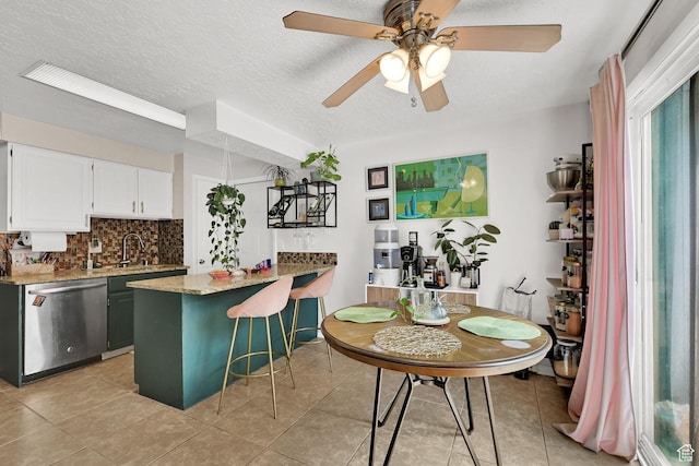 720 S 1650 E Unit B, Clearfield, UT 84015 - kitchen featuring stainless steel dishwasher, tasteful backsplash, a ceiling fan, light tile patterned floors, and light stone countertops