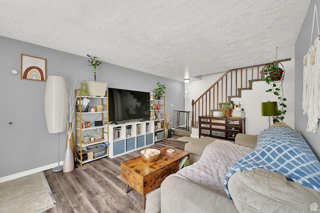 720 S 1650 E Unit B, Clearfield, UT 84015 - living area featuring stairs, wood finished floors, a textured ceiling, and baseboards