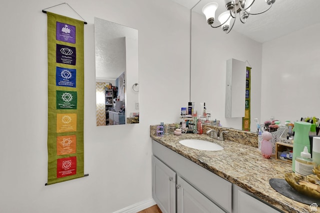 720 S 1650 E Unit B, Clearfield, UT 84015 - bathroom with vanity, a chandelier, and a textured ceiling