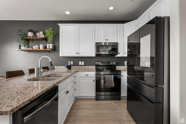 152 S 930 E, American Fork, UT 84003 - kitchen featuring black appliances, a sink, white cabinets, recessed lighting, and light stone countertops