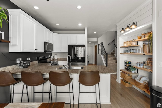 152 S 930 E, American Fork, UT 84003 - kitchen featuring black microwave, stainless steel electric range, a peninsula, refrigerator, and a sink