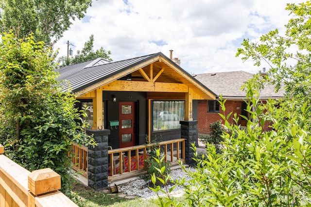 1190 E Sherman Ave S, Salt Lake City, UT 84105 - view of front of property with a standing seam roof, metal roof, covered porch, and a shingled roof