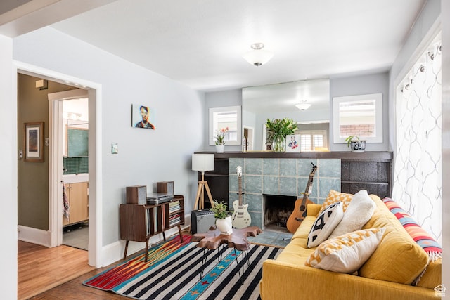 1190 E Sherman Ave S, Salt Lake City, UT 84105 - living room with a fireplace, wood finished floors, and baseboards