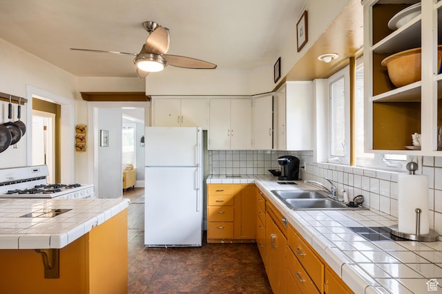 1190 E Sherman Ave S, Salt Lake City, UT 84105 - kitchen with white appliances, a sink, tile counters, and tasteful backsplash