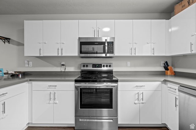 64 W 600 S Unit C205, Springville, UT 84663 - kitchen with appliances with stainless steel finishes, white cabinetry, and wood finished floors