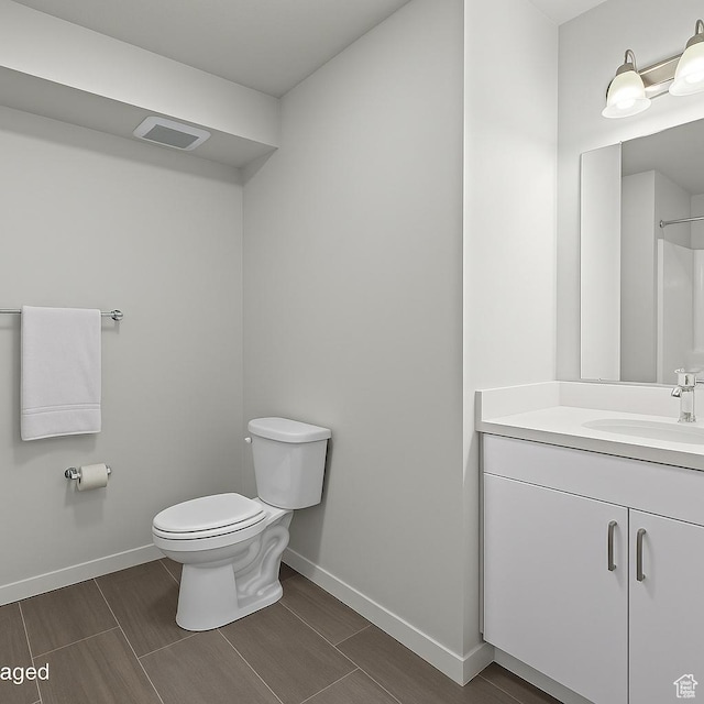 64 W 600 S Unit C205, Springville, UT 84663 - bathroom featuring toilet, baseboards, vanity, and wood finish floors