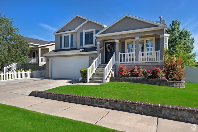 4952 W Buffalo Ct S, Riverton, UT 84096 - tri-level home with a porch, an attached garage, driveway, and stucco siding
