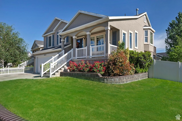 4952 W Buffalo Ct S, Riverton, UT 84096 - view of front facade with a porch, a garage, stucco siding, and concrete driveway