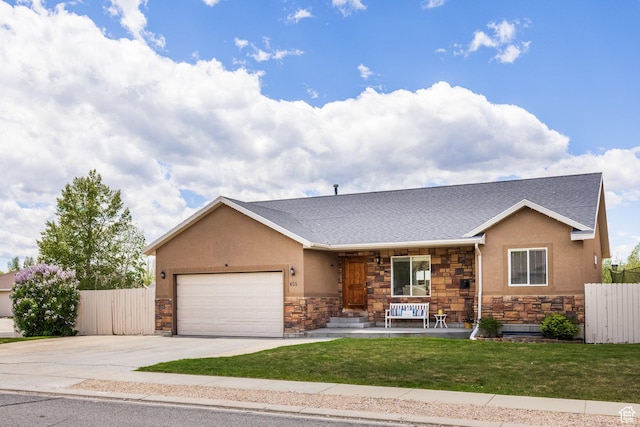 455 N 100 W Unit C-80, Kamas, UT 84036 - view of front of home featuring stone siding, a porch, an attached garage, and concrete driveway