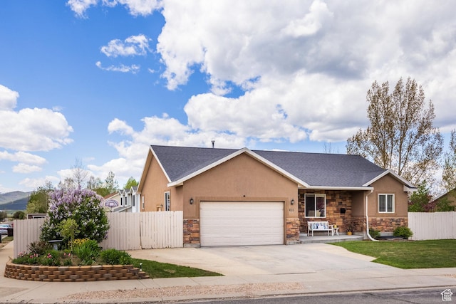 455 N 100 W Unit C-80, Kamas, UT 84036 - view of front of property with stone siding, a garage, concrete driveway, stucco siding, and covered porch