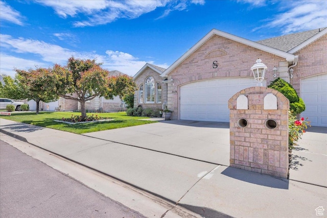 519 W 40 N, Orem, UT 84057 - view of front facade with concrete driveway, an attached garage, a front yard, and stone siding