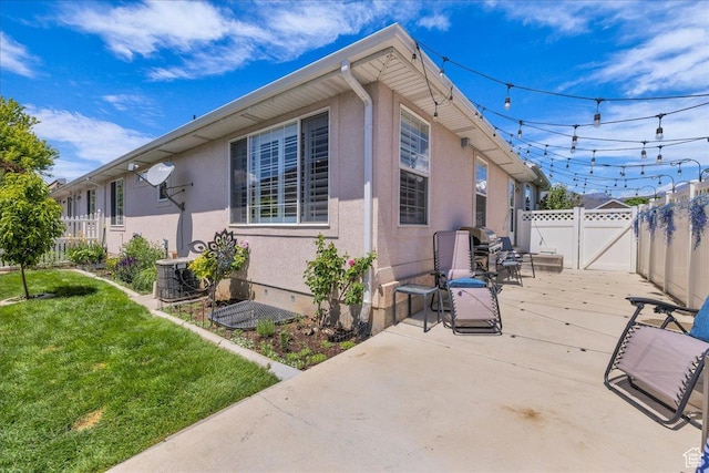 519 W 40 N, Orem, UT 84057 - view of side of property featuring stucco siding, a patio area, a gate, and central AC unit