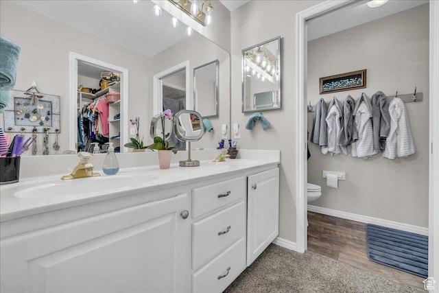 519 W 40 N, Orem, UT 84057 - full bathroom with double vanity, toilet, a walk in closet, and baseboards