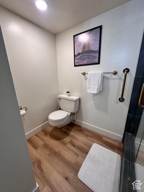 875 S Donner Way E Unit 208, Salt Lake City, UT 84108 - full bath featuring toilet, wood finished floors, baseboards, and a shower with shower door