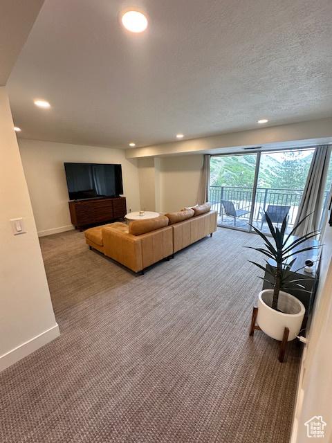875 S Donner Way E Unit 208, Salt Lake City, UT 84108 - carpeted living area featuring baseboards and recessed lighting