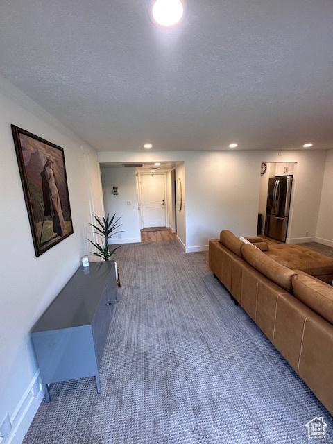 875 S Donner Way E Unit 208, Salt Lake City, UT 84108 - living area with carpet flooring, baseboards, a textured ceiling, and recessed lighting
