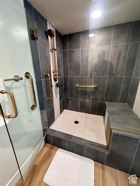 875 S Donner Way E Unit 208, Salt Lake City, UT 84108 - full bath featuring wood finished floors and a shower stall