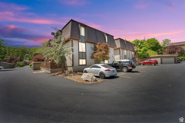 5420 Willow Ln Unit F, Murray, UT 84107 - view of front of house with mansard roof, roof with shingles, and uncovered parking