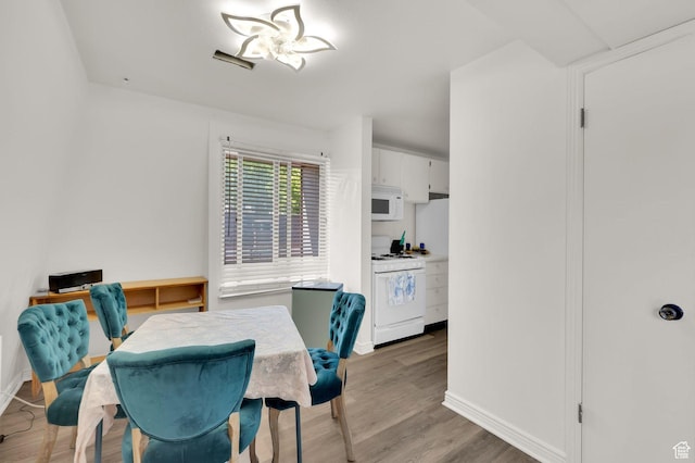 5420 Willow Ln Unit F, Murray, UT 84107 - dining room with baseboards and light wood-style floors